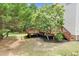 Multi-tiered wooden deck overlooking backyard with mature trees at 8820 Waynick Dr, Raleigh, NC 27617