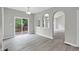 Dining area features sliding glass doors to deck and open archway to living area at 8820 Waynick Dr, Raleigh, NC 27617