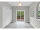 Dining area with sliding glass doors to deck and view of the lush green landscape at 8820 Waynick Dr, Raleigh, NC 27617