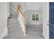Inviting entryway with a staircase and views of the living room with lots of natural light at 8820 Waynick Dr, Raleigh, NC 27617