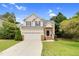 Charming two-story home with a well-maintained lawn, attached garage, and classic architectural details at 8820 Waynick Dr, Raleigh, NC 27617