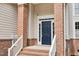 Charming front door with brick columns and well-maintained landscaping at 8820 Waynick Dr, Raleigh, NC 27617