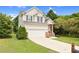 Attached two-car garage on a charming two-story home with a well-maintained lawn at 8820 Waynick Dr, Raleigh, NC 27617
