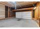 View of an unfinished garage, showing the white paneled garage door at 8820 Waynick Dr, Raleigh, NC 27617