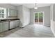 Bright kitchen and breakfast area with stainless steel appliances and access to deck at 8820 Waynick Dr, Raleigh, NC 27617