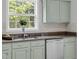Stylish kitchen sink area with garden window for ample natural light at 8820 Waynick Dr, Raleigh, NC 27617