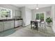 Bright kitchen with island, stainless steel appliances, and access to the outdoor deck at 8820 Waynick Dr, Raleigh, NC 27617