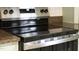 Modern black glass cooktop with stainless steel trim and speckled countertop at 8820 Waynick Dr, Raleigh, NC 27617