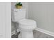 Neutral bathroom with white toilet and a decorative plant on top at 8820 Waynick Dr, Raleigh, NC 27617