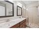 Spacious bathroom with double vanity, updated lighting, and glass shower at 904 Palm Ct, Mebane, NC 27302