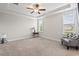 Spacious bedroom with neutral carpet, ceiling fan, and decorative tray ceiling at 904 Palm Ct, Mebane, NC 27302