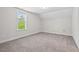 Bright bedroom with neutral carpet, window with blinds, and fresh paint at 904 Palm Ct, Mebane, NC 27302
