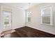 Dining area with hardwood floors, modern chandelier, and access to the back porch at 904 Palm Ct, Mebane, NC 27302