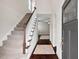 Inviting entryway with hardwood floors, staircase, and view into the living area at 904 Palm Ct, Mebane, NC 27302