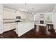 Bright kitchen open to living area features granite counters and stainless steel appliances at 904 Palm Ct, Mebane, NC 27302