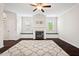 Cozy living room featuring a fireplace, hardwood floors, and built-in bench seating at 904 Palm Ct, Mebane, NC 27302