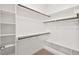 Walk-in closet with carpeted floor, multiple shelves, and clothes rods at 904 Palm Ct, Mebane, NC 27302