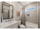 Stylish bathroom featuring a marble vanity, tiled walls, and a shower-tub combination at 905 E Lenoir St, Raleigh, NC 27610