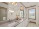 Bright bathroom featuring double vanity with gray countertop and tiled walk-in shower with built-in niche at 905 E Lenoir St, Raleigh, NC 27610