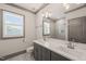 Bright bathroom featuring a double sink vanity, large mirror, and walk-in shower with gray subway tiles at 905 E Lenoir St, Raleigh, NC 27610