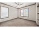 Neutral bedroom with a ceiling fan, carpeted floor, and windows dressed with white plantation shutters at 905 E Lenoir St, Raleigh, NC 27610