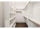 Spacious walk-in closet with custom shelving, hanging rods, and hardwood flooring at 905 E Lenoir St, Raleigh, NC 27610