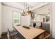 Bright dining area showcasing an open layout and a modern table, flowing into the kitchen at 905 E Lenoir St, Raleigh, NC 27610