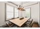 Bright dining room featuring a modern wood table, stylish chairs, and an eye-catching light fixture at 905 E Lenoir St, Raleigh, NC 27610