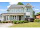 Charming two-story home with a covered porch and manicured landscaping at 905 E Lenoir St, Raleigh, NC 27610