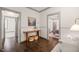 Hallway with hardwood floors, wainscoting, leading to various rooms, with stylish console table at 905 E Lenoir St, Raleigh, NC 27610