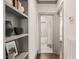 Hallway with built-in shelving leading to bathroom showcasing modern fixtures and tiling at 905 E Lenoir St, Raleigh, NC 27610