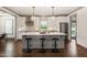 Modern kitchen with a gray island, stainless steel appliances, pendant lights, and tile backsplash at 905 E Lenoir St, Raleigh, NC 27610