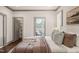 Well-decorated main bedroom with hardwood floors, a walk-in closet, and an adjacent sunroom at 905 E Lenoir St, Raleigh, NC 27610