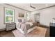 Well-lit main bedroom with hardwood floors, king bed, plantation shutters, and ensuite at 905 E Lenoir St, Raleigh, NC 27610