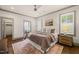 Elegant main bedroom with hardwood floors, king bed, sitting area, and plantation shutters at 905 E Lenoir St, Raleigh, NC 27610