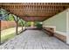 Covered patio featuring stone flooring, exposed wooden beams, and a view of the backyard at 905 E Lenoir St, Raleigh, NC 27610