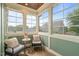Cozy sunroom featuring comfortable seating, wood floors, and ample natural light at 905 E Lenoir St, Raleigh, NC 27610
