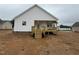 View of the home's backyard featuring a cozy, screened-in deck and wood stairs at 94 Royal Ave, Selma, NC 27576