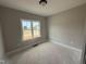 Cozy bedroom features bright window offering natural light and neutral walls, perfect for relaxation at 94 Royal Ave, Selma, NC 27576