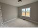 Neutral-toned bedroom featuring a bright window overlooking the exterior at 94 Royal Ave, Selma, NC 27576