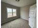 Neutral bedroom featuring carpet, fresh paint, a double-hung window, and an expansive closet at 94 Royal Ave, Selma, NC 27576