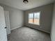 Neutral bedroom featuring carpet, fresh paint, a double-hung window, and an expansive closet at 94 Royal Ave, Selma, NC 27576