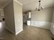 Open-concept dining room with modern chandelier and an opening to the kitchen and an adjacent living room space at 94 Royal Ave, Selma, NC 27576