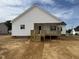 New home featuring white siding and a covered deck with wooden stairs at 94 Royal Ave, Selma, NC 27576