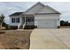 Charming single-Gathering home featuring a two-car garage, welcoming front porch, and modern farmhouse design at 94 Royal Ave, Selma, NC 27576