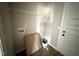 A new, clean laundry room with shelving, utility hookups, new floors, and fresh paint at 94 Royal Ave, Selma, NC 27576