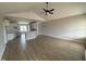 Bright and open living area featuring hardwood floors and an elegant ceiling fan and views into an open kitchen at 94 Royal Ave, Selma, NC 27576