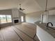 Spacious living room boasts vaulted ceilings, modern fireplace, and seamless flow to the kitchen, perfect for entertaining at 94 Royal Ave, Selma, NC 27576