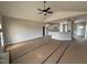 Open-concept living room showcasing vaulted ceilings, ceiling fan, and seamless transition to the kitchen at 94 Royal Ave, Selma, NC 27576