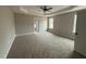 Large main bedroom featuring carpet, neutral walls, a ceiling fan, and lots of light at 94 Royal Ave, Selma, NC 27576